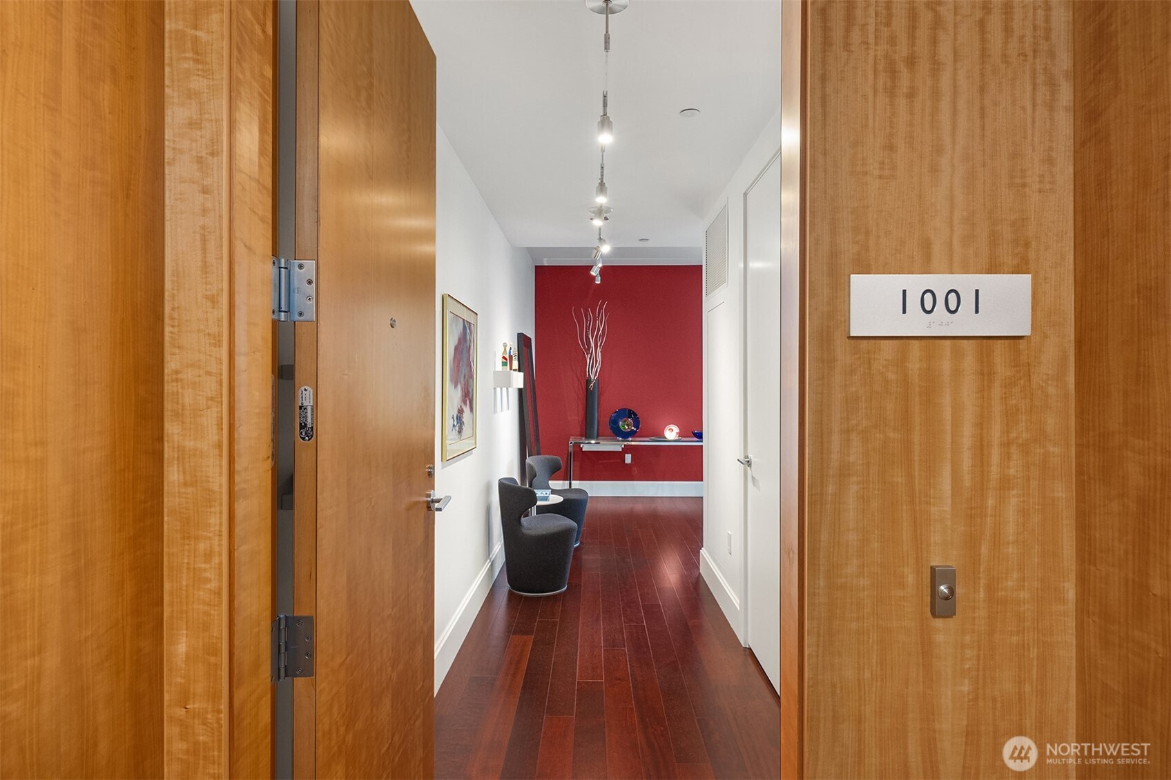 1521 2nd Avenue, Unit 1001 Seattle, WA 98101 - Photo 2 of 37 a view of a hallway with wooden floor