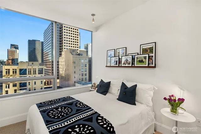 a bedroom with a large bed and a window