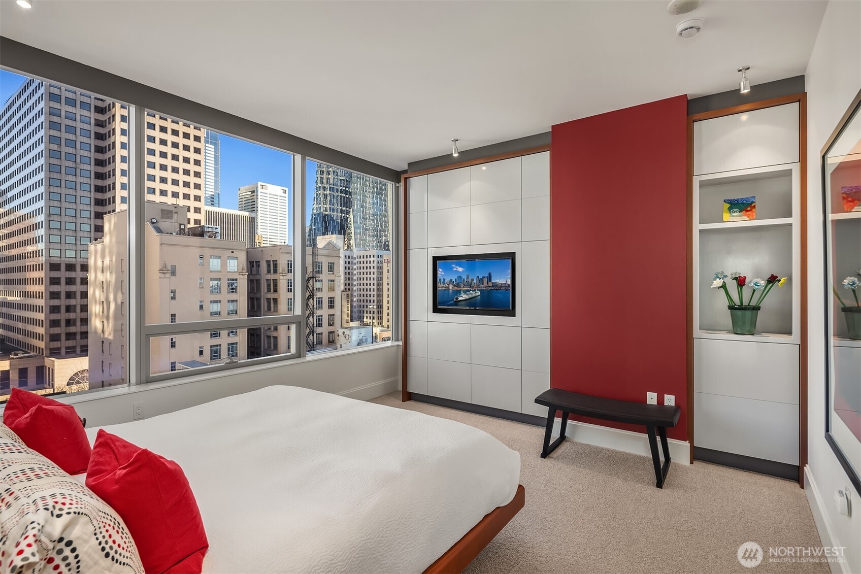 1521 2nd Avenue, Unit 1001 Seattle, WA 98101 - Photo 23 of 37 a bedroom with a bed and a potted plant