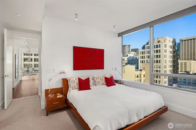 a bedroom with a large bed and a chandelier