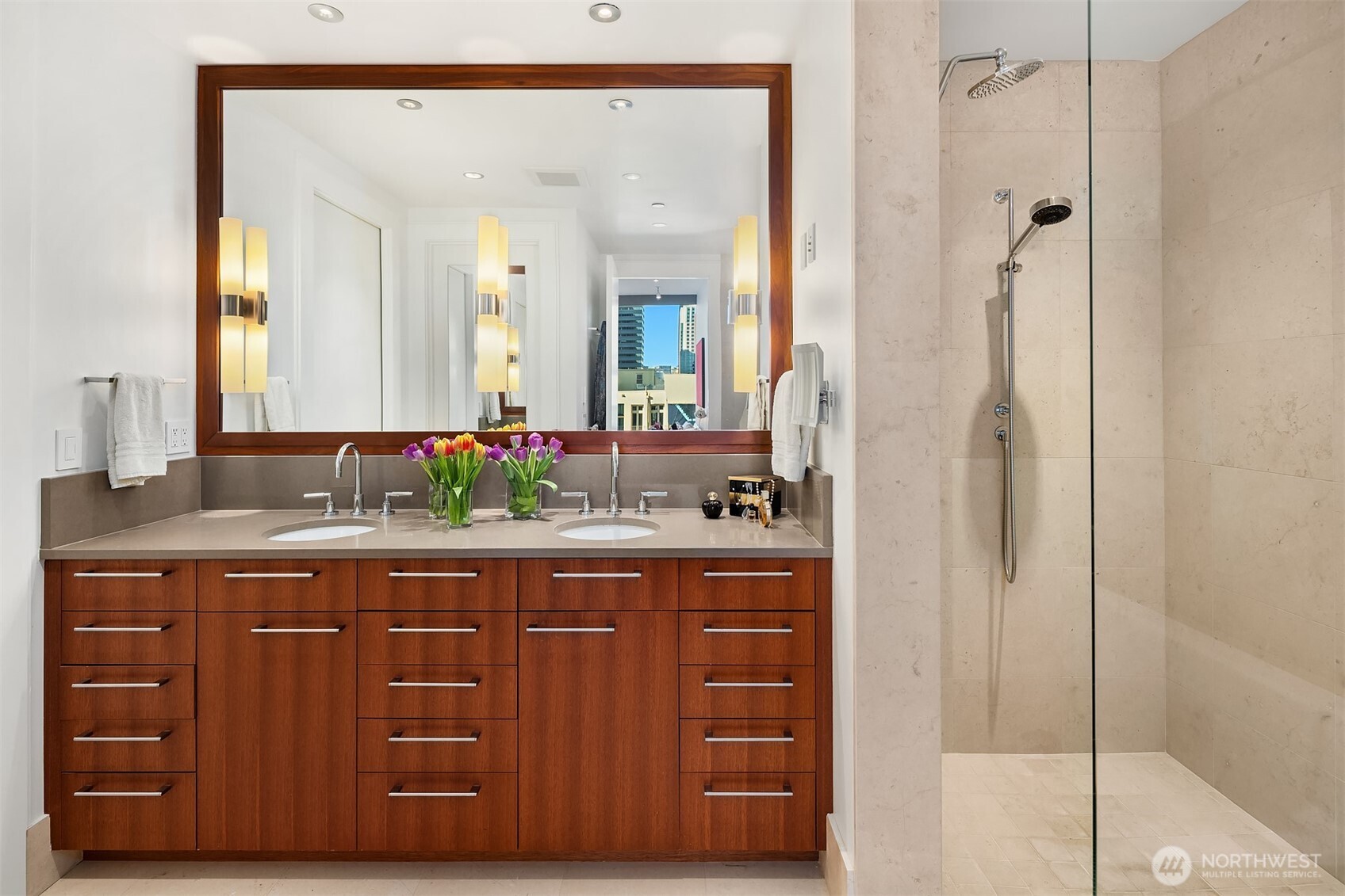 1521 2nd Avenue, Unit 1001 Seattle, WA 98101 - Photo 25 of 37 a bathroom with a granite countertop sink and a mirror