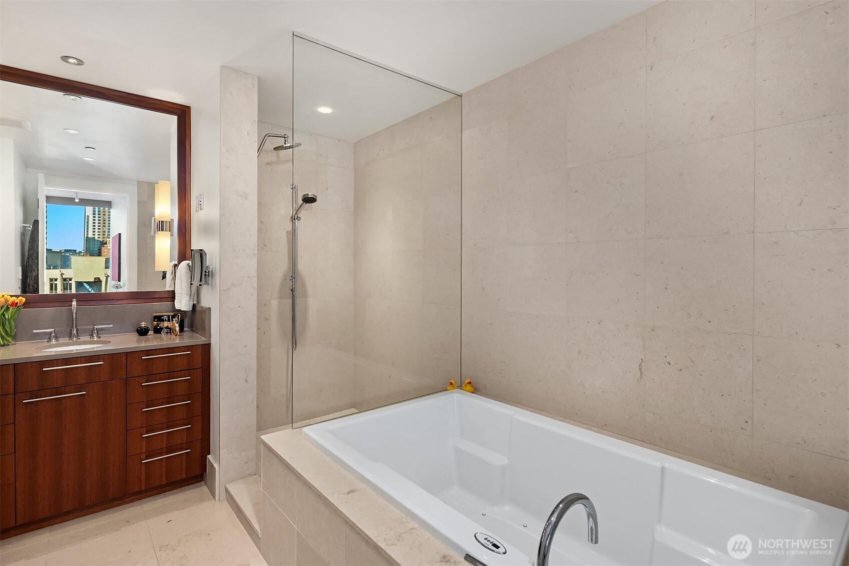 1521 2nd Avenue, Unit 1001 Seattle, WA 98101 - Photo 27 of 37 a bathroom with a tub sink and mirror