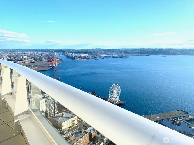 a backyard of a house with fountain table and chairs