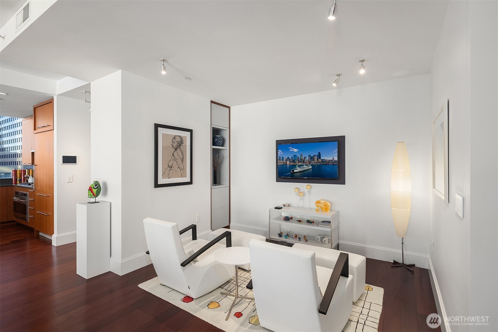 1521 2nd Avenue, Unit 1001 Seattle, WA 98101 - Photo 6 of 37 a living room with furniture and a flat screen tv