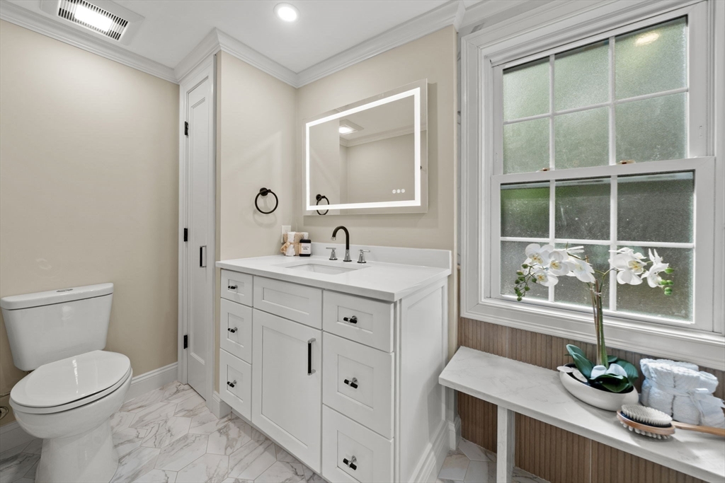 162 High Street, Unit B Danvers, MA 01923 - Photo 17 of 32 a bathroom with a sink vanity granite and a toilet