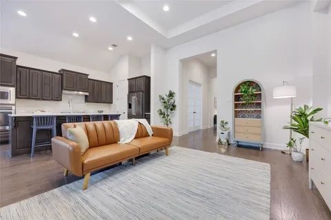 a living room with furniture and wooden floor