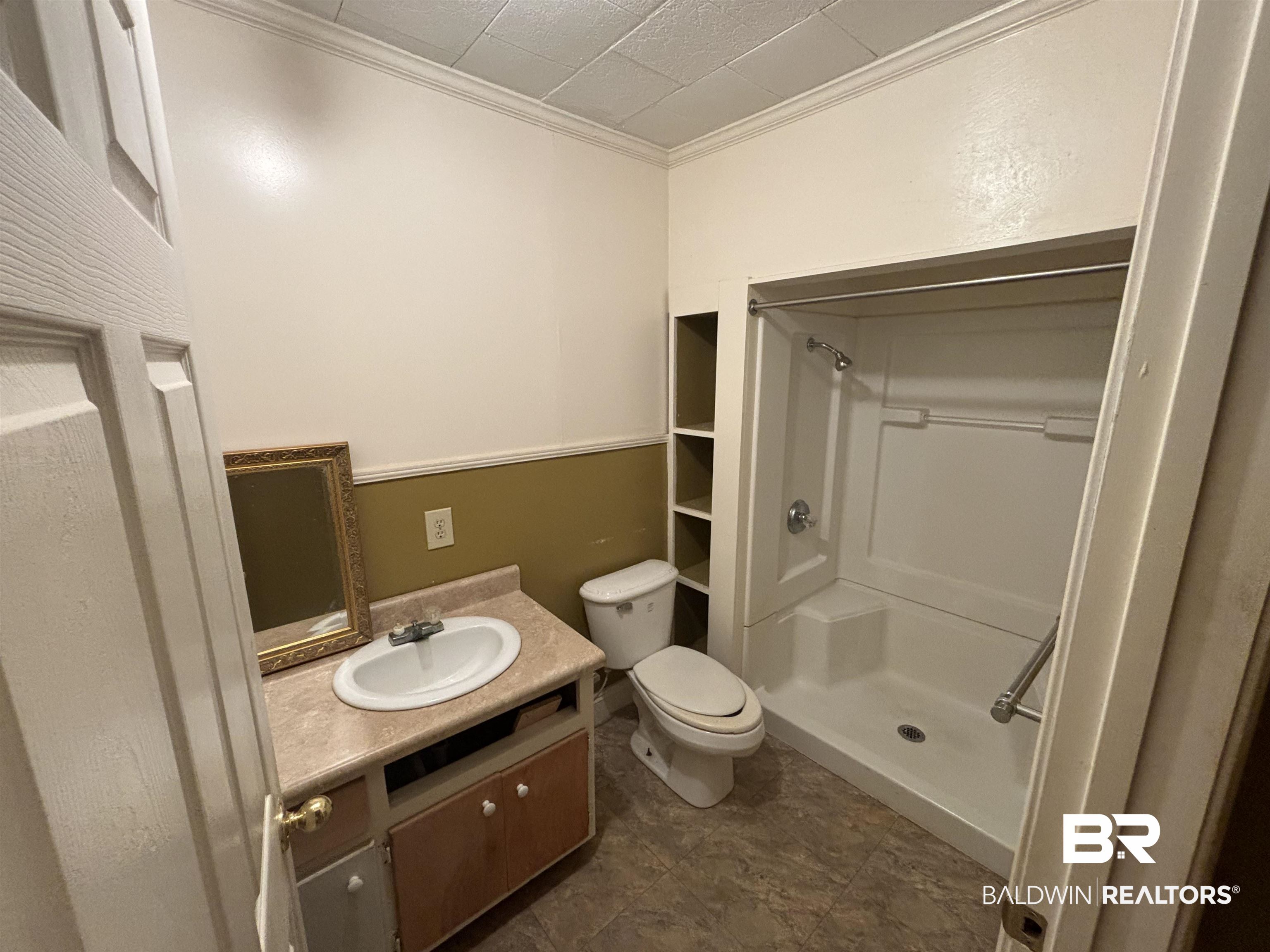 17495 County Road 48 Robertsdale, AL 36567 - Photo 31 of 37 Bathroom featuring walk in shower, ornamental molding, vanity, and toilet