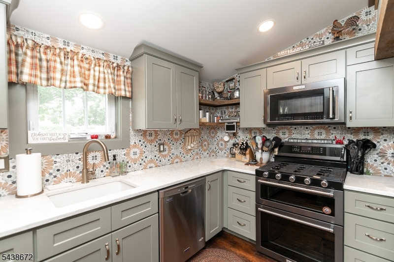 36 Main Street Flanders, NJ 07836 - Photo 7 of 31 a kitchen with stainless steel appliances a stove a sink and a microwave