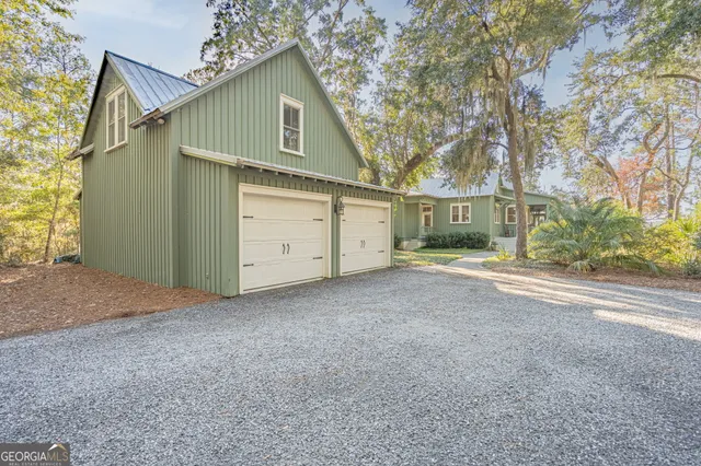 a view of a house with a yard and garage
