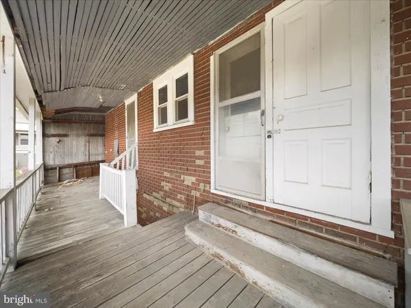 a view of a backyard of a house with wooden floor and fence