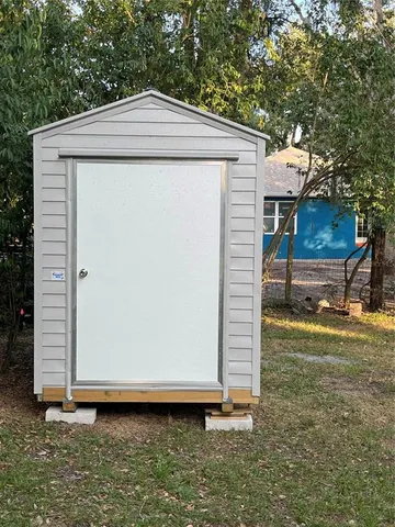 a view of a hallway with wooden floor and stairs
