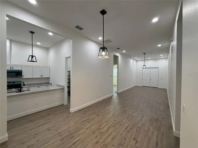 a view of a kitchen with a sink and a refrigerator