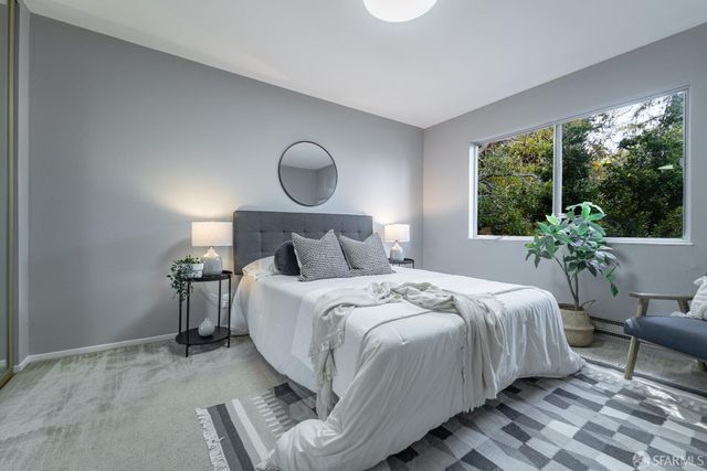 a bedroom with a bed potted plant and a window