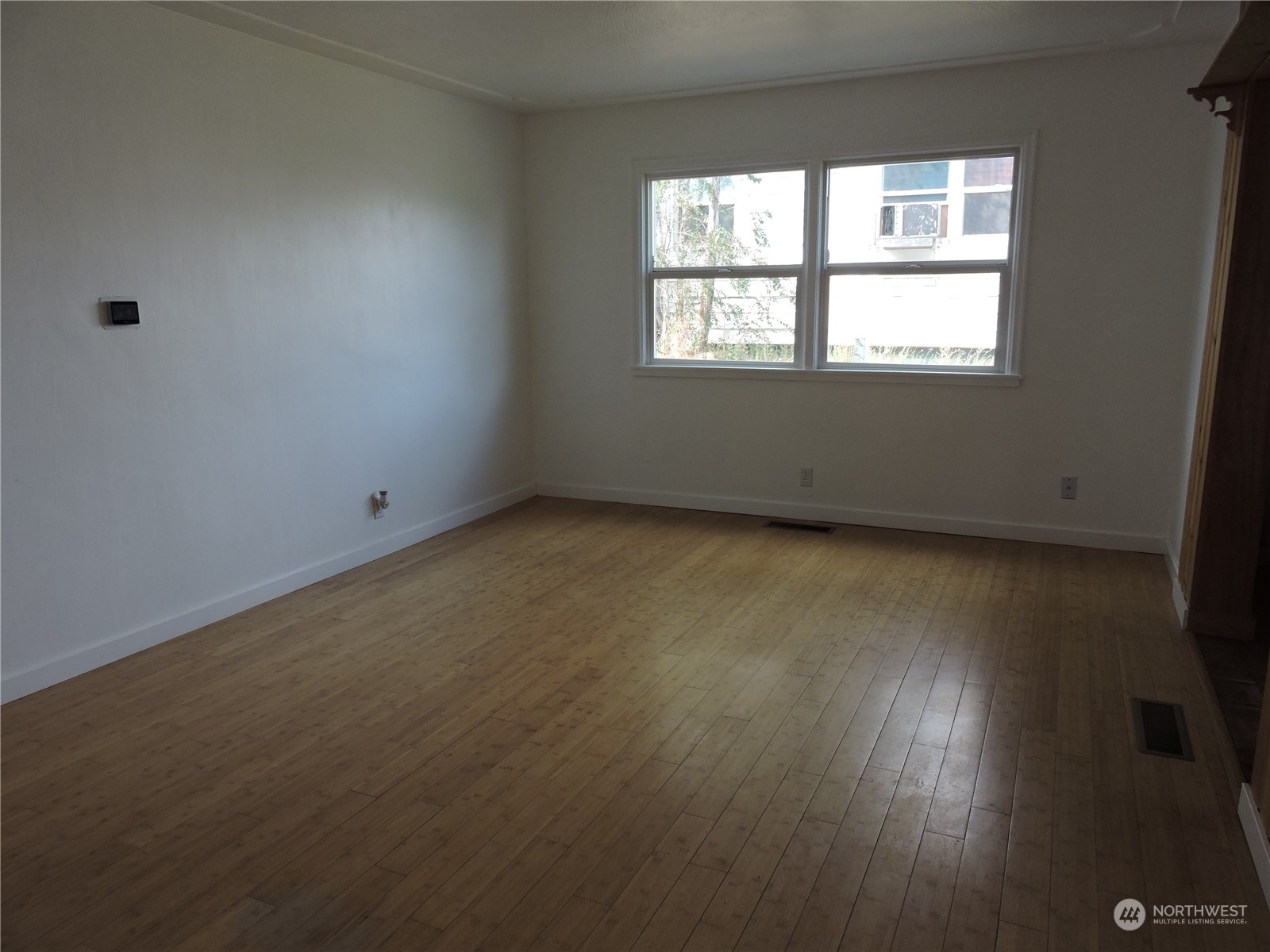 227 Columbia Road Ephrata, WA 98823 - Photo 2 of 21 an empty room with wooden floor and windows