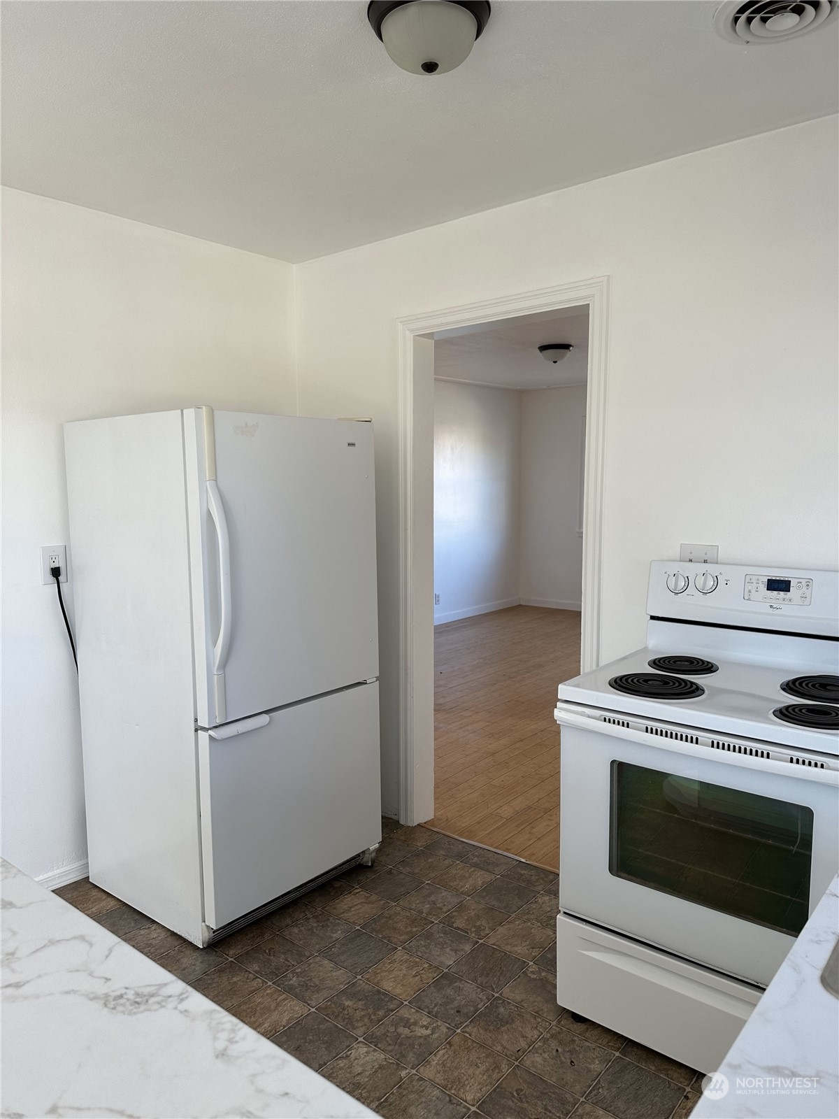 227 Columbia Road Ephrata, WA 98823 - Photo 8 of 21 a kitchen with a stove and a refrigerator