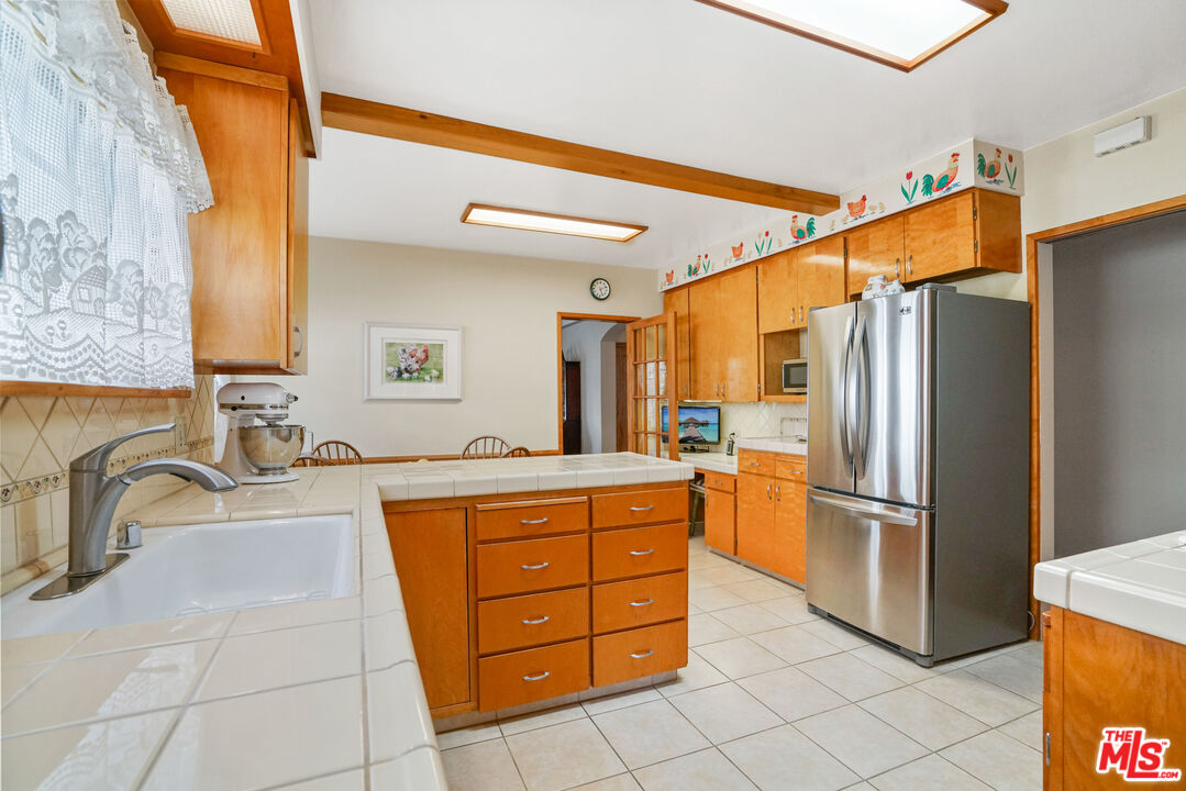 1215 North Everett Street Glendale, CA 91207 - Photo 12 of 31 a kitchen with stainless steel appliances granite countertop a refrigerator and a sink