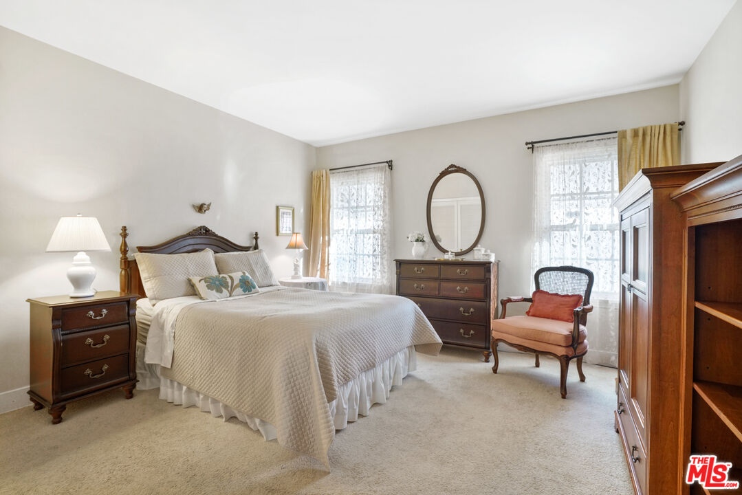 1215 North Everett Street Glendale, CA 91207 - Photo 13 of 31 a bedroom with a bed and a chandelier