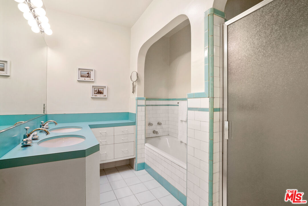 1215 North Everett Street Glendale, CA 91207 - Photo 15 of 31 a bathroom with a tub sink and mirror