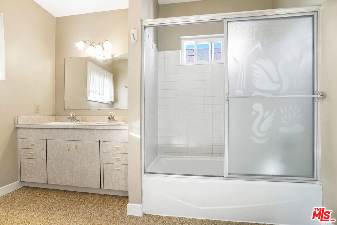 1215 North Everett Street Glendale, CA 91207 - Photo 20 of 31 a bathroom with a shower sink and mirror