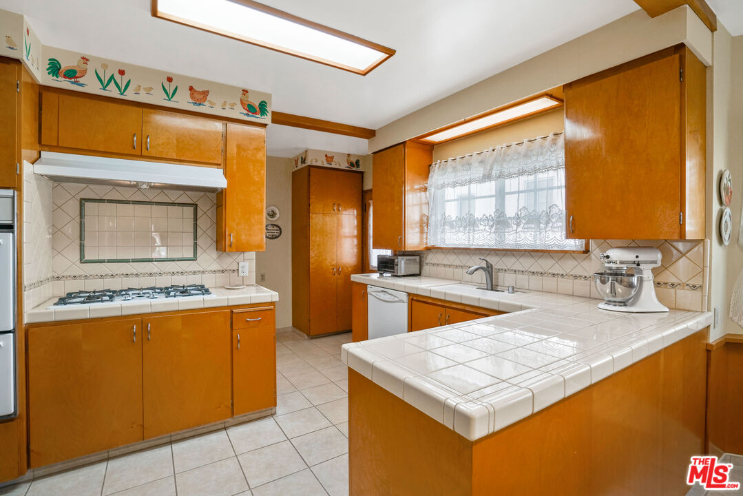 1215 North Everett Street Glendale, CA 91207 - Photo 10 of 31 a kitchen with a sink a stove top oven and a counter top space
