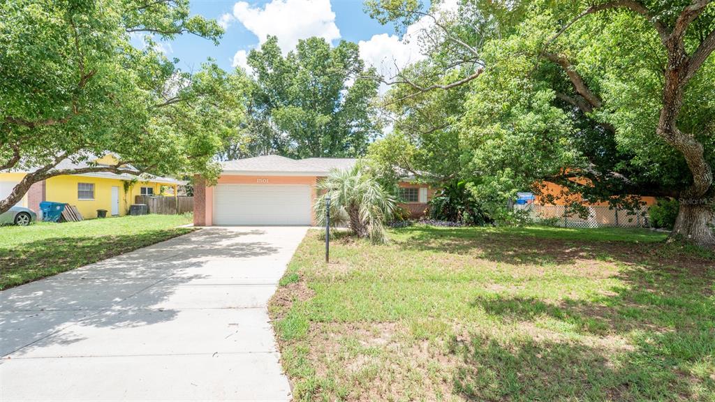 1501 Bishop Road Spring Hill, FL 34608 - Photo 1 of 1 a front view of a house with garden