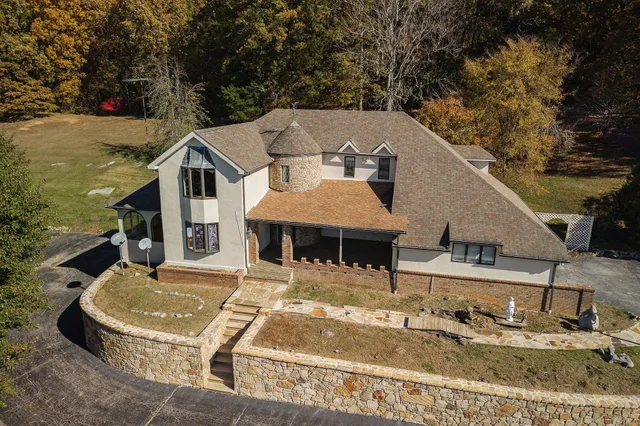 a view of a building with a fountain in a patio