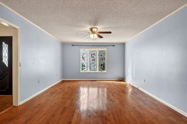 a view of a kitchen with an entryway and an empty room