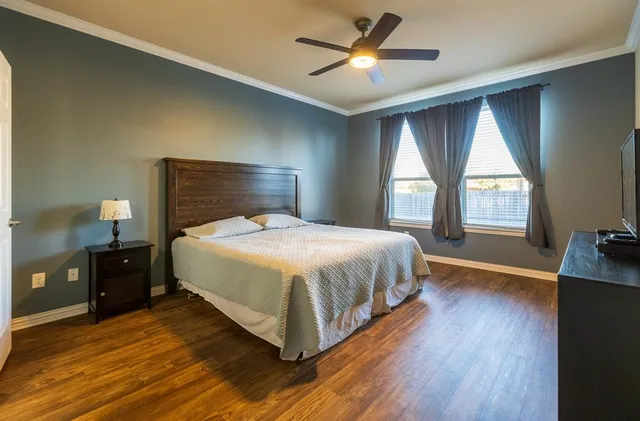 a bedroom with a large bed and a large window