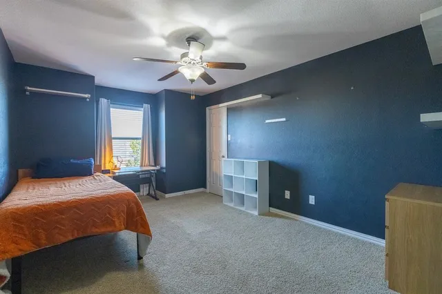 a bedroom with a bed and window