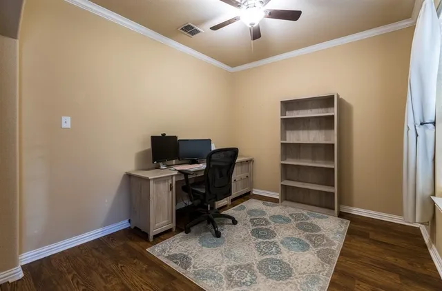 a view of workspace with wooden floor lounge chair and cabinet