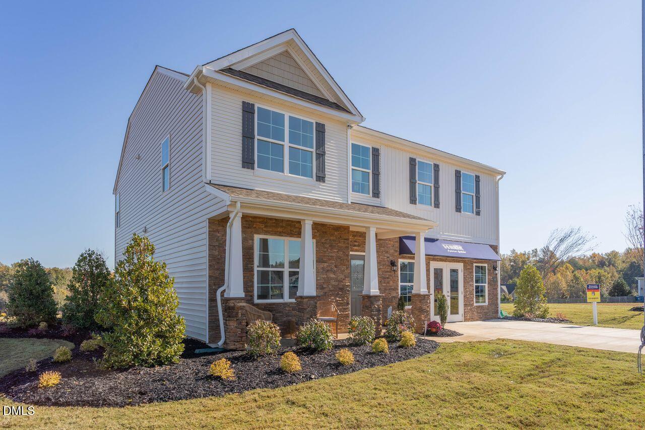 7070 Stockard Road Snow Camp, NC 27349 - Photo 1 of 38 a front view of a house with garden and patio