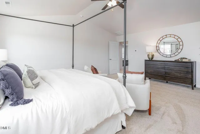 a bed room with a bed mirror and a table