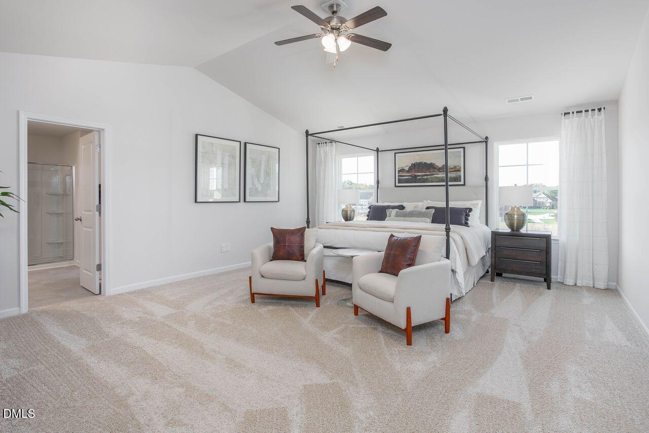 7070 Stockard Road Snow Camp, NC 27349 - Photo 25 of 38 a bed room with a bed and a chandelier