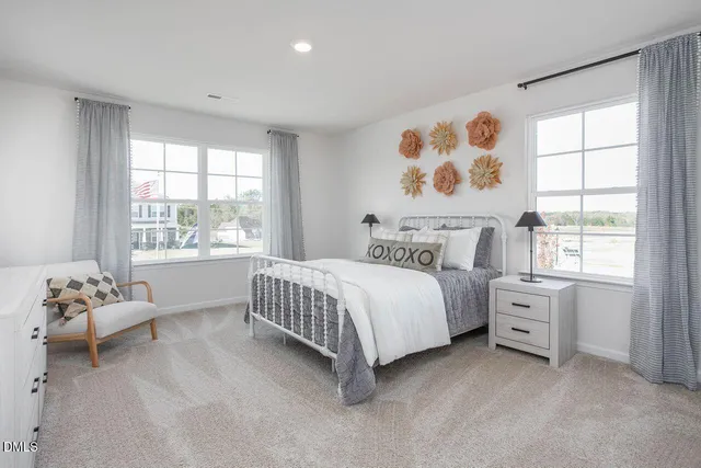 a spacious bedroom with a bed and a window