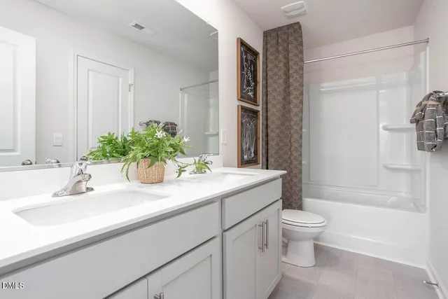 a bathroom with a granite countertop sink a toilet and bathtub