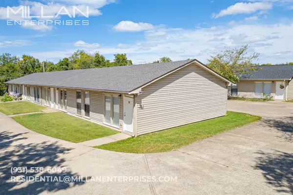 a aerial view of a house next to a yard