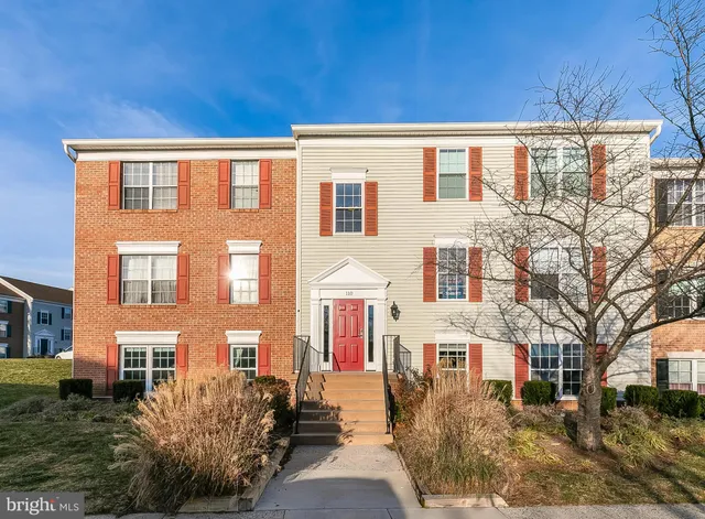 a front view of a building with a yard