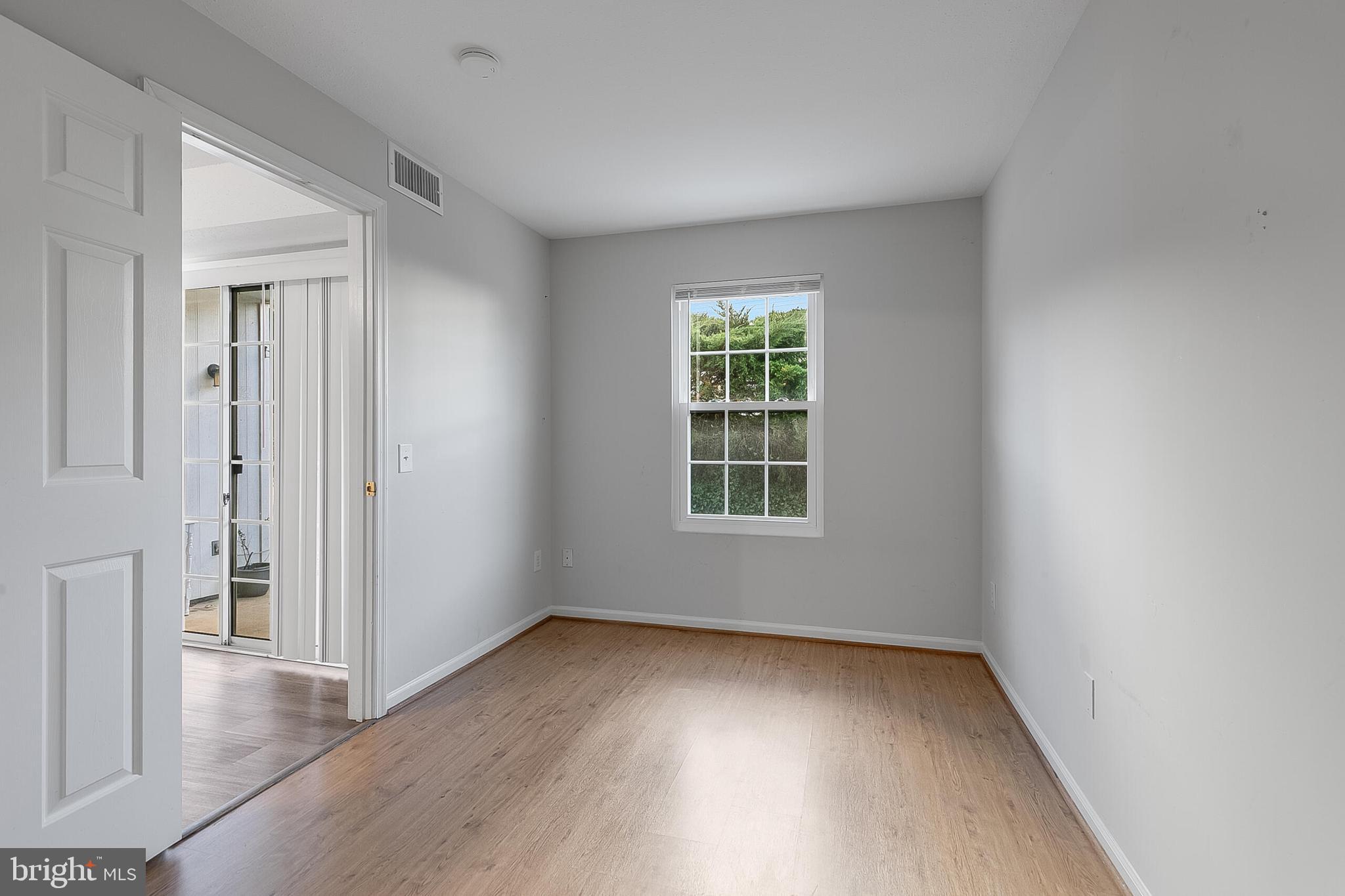 110 Prosperity Avenue Southeast, Unit A Leesburg, VA 20175 - Photo 11 of 22 an empty room with wooden floor and windows