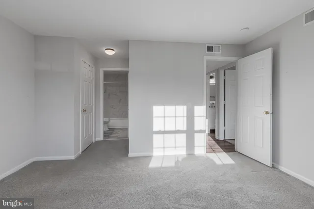a view of empty room with a fireplace