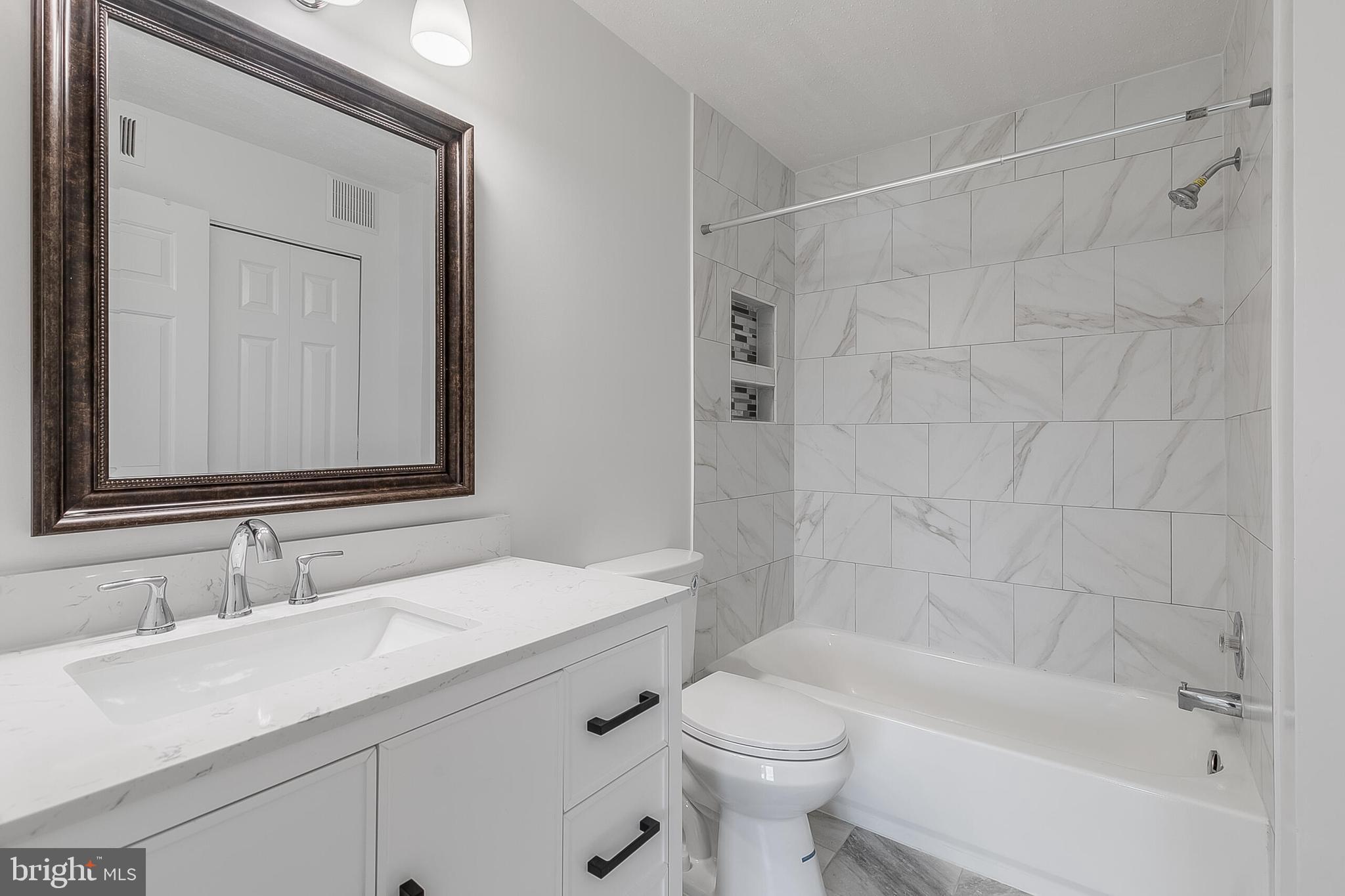 110 Prosperity Avenue Southeast, Unit A Leesburg, VA 20175 - Photo 17 of 22 a bathroom with a sink toilet and shower