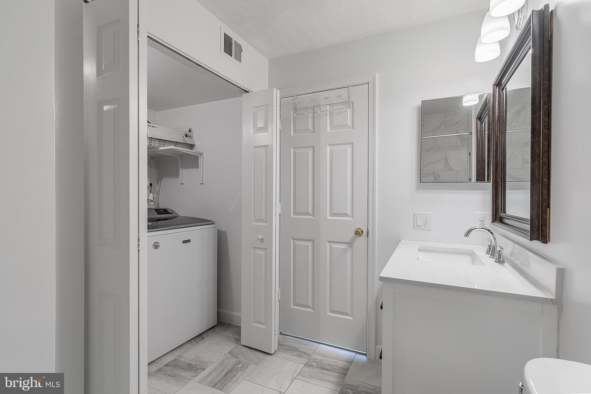 110 Prosperity Avenue Southeast, Unit A Leesburg, VA 20175 - Photo 20 of 22 a bathroom with a sink and mirror