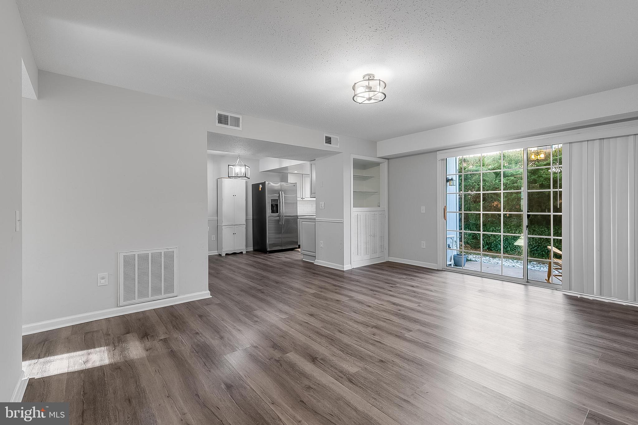 110 Prosperity Avenue Southeast, Unit A Leesburg, VA 20175 - Photo 2 of 22 a view of empty room with wooden floor and fan