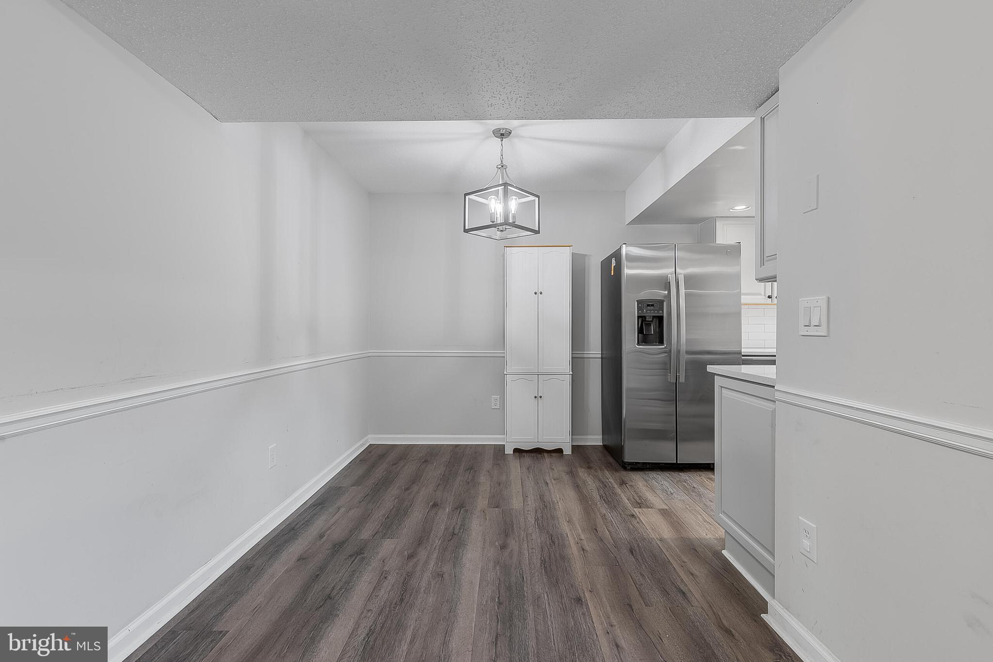110 Prosperity Avenue Southeast, Unit A Leesburg, VA 20175 - Photo 3 of 22 a view of a room with wooden floor electronic appliances and furniture