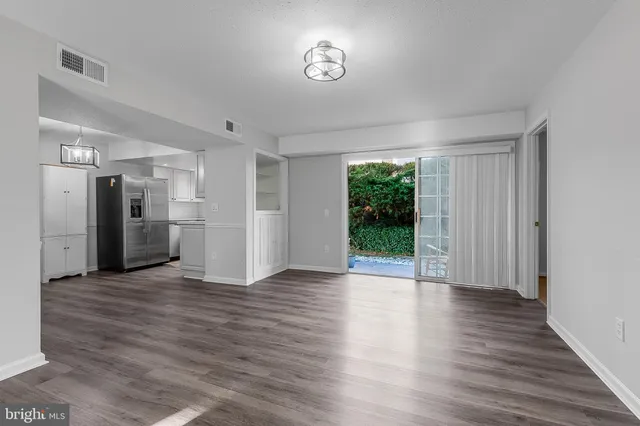 a view of a big room with wooden floor garden view and a window