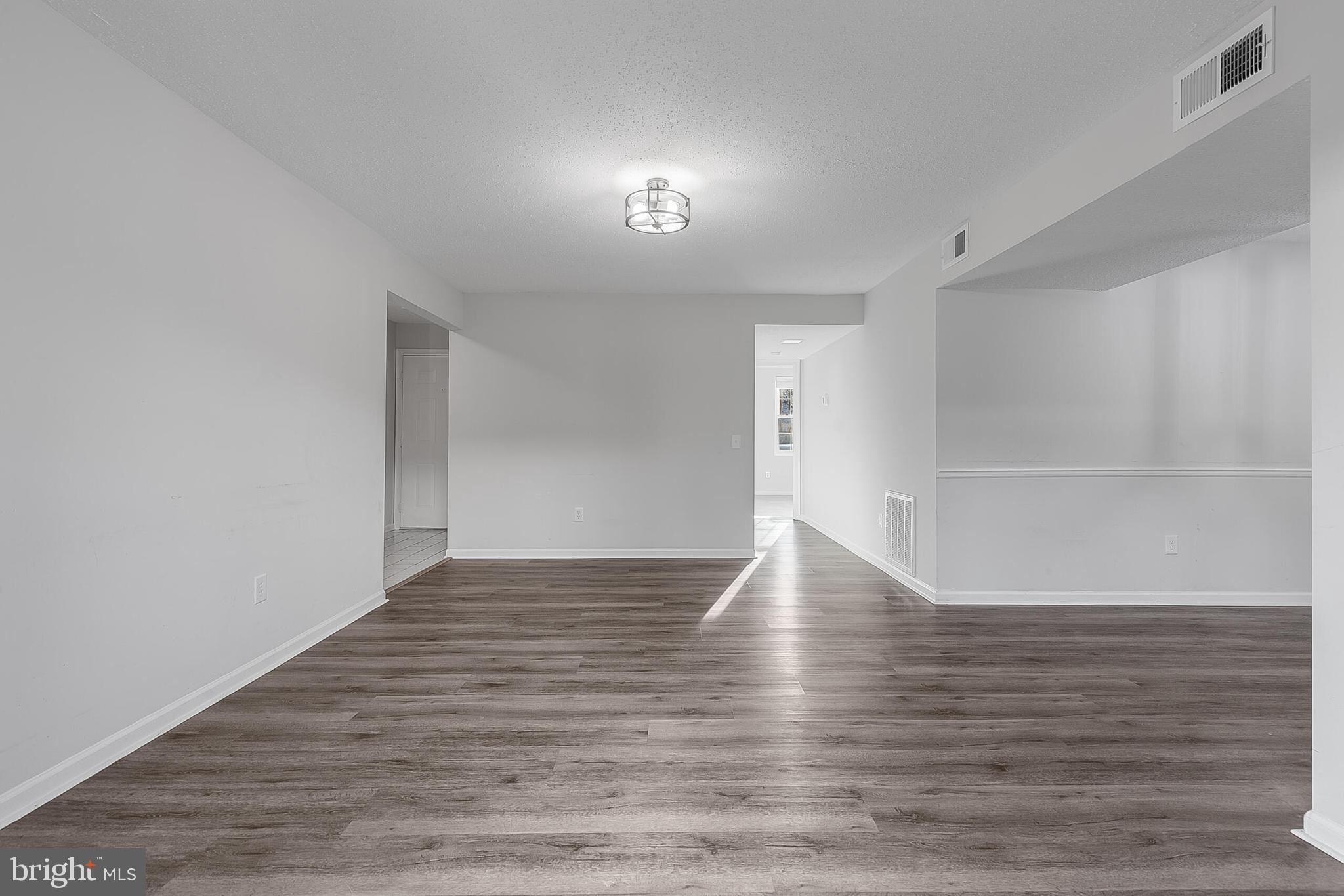 110 Prosperity Avenue Southeast, Unit A Leesburg, VA 20175 - Photo 9 of 22 a view of an empty room with wooden floor