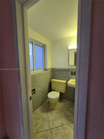 a bathroom with a sink a toilet and bathtub
