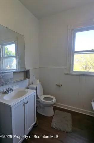 a bathroom with a toilet sink and window