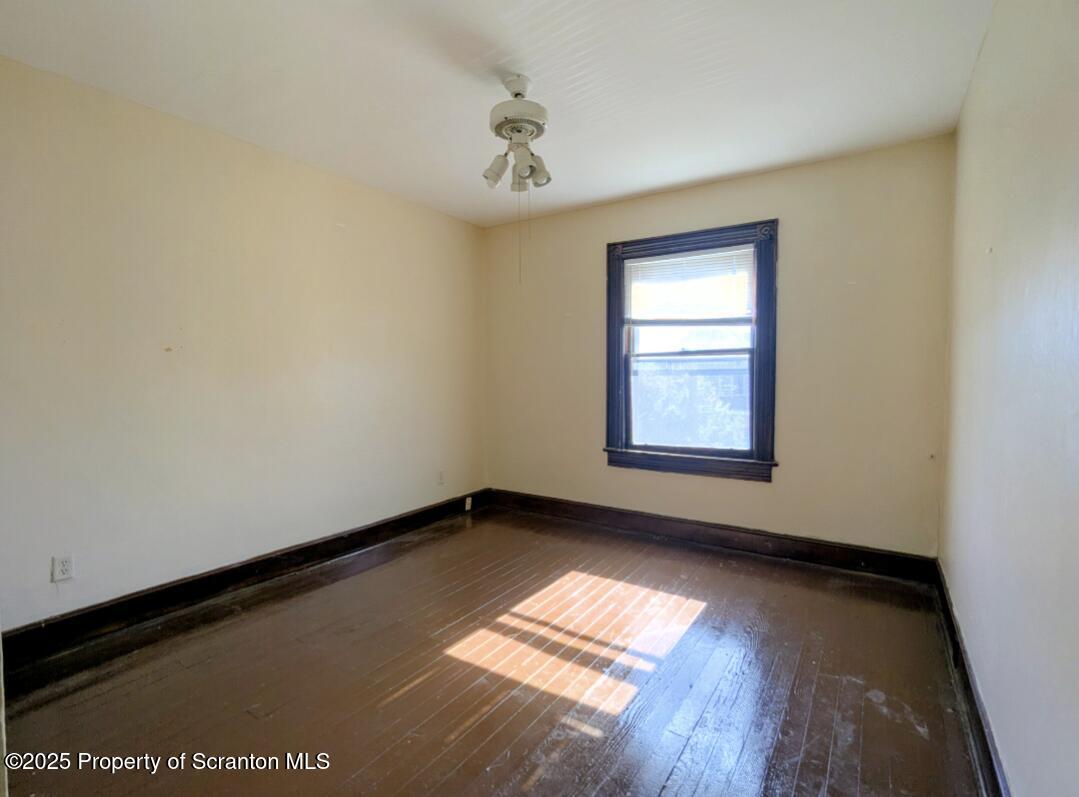 1220 Schlager Street Scranton, PA 18504 - Photo 8 of 10 a view of empty room with wooden floor and fan