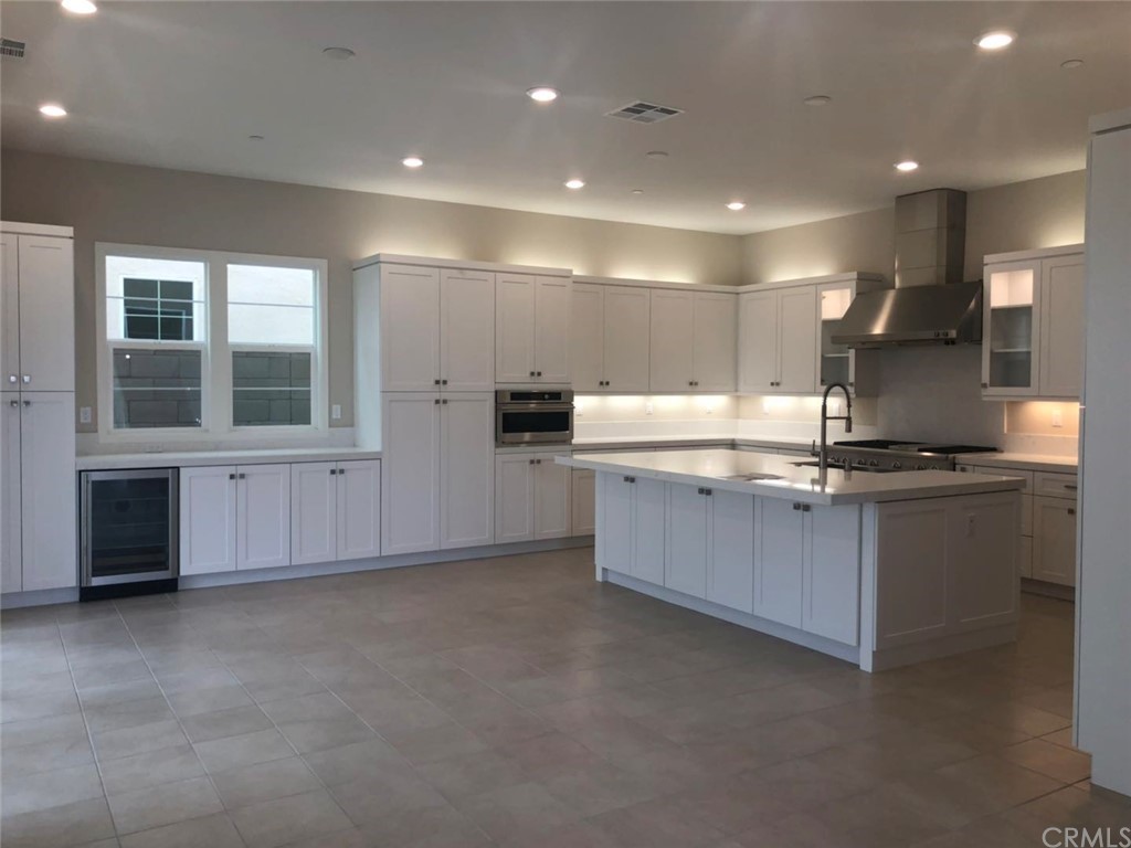 117 Swift Irvine, CA 92618 - Photo 2 of 4 a large kitchen with stainless steel appliances kitchen island a large counter top and a sink