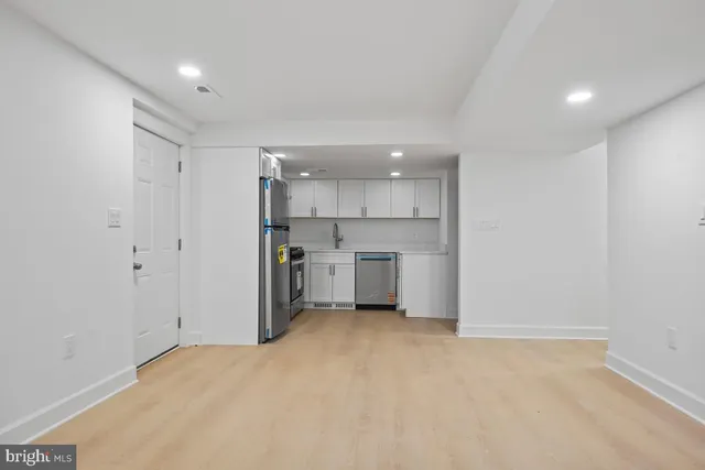a kitchen with a refrigerator and a sink